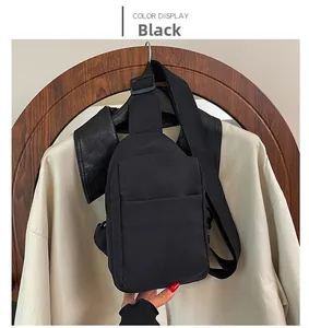 Close-up of a black waterproof nylon crossbody chest bag with adjustable strap and zip pocket
