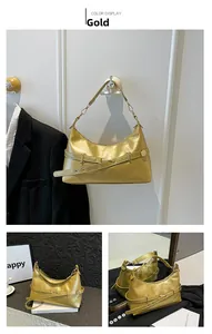 Detail view of gold crescent hobo bag with sleek metallic finish and buckle hardware