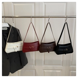 Detail view of four baguette shoulder bags in cream, burgundy, brown, and black colors