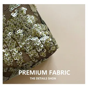 Close-up of premium black mesh fabric with champagne sequins on a fashion clutch