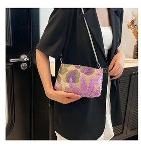 Close-up of floral embroidery and purple sequins on a chic chain crossbody bag