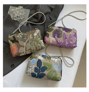 Detailed view of sequined floral embroidery on elegant chain bags in various colors