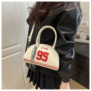 Detail of white glossy leather bag with red Los Angeles print and silver chain link