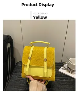 Detail of yellow quilted backpack with woven texture and elegant metal buckle