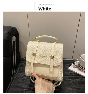 Detail of white woven texture flap and golden handle on stylish dual-use backpack