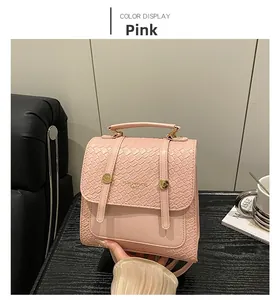Detail view of pink PU leather mini backpack with woven flap texture on wood table