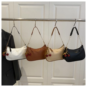 Detail of four crescent shoulder bags in white, brown, beige, and black with cherry charms