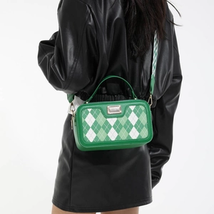 Green and white quilted crossbody bag with argyle pattern and wide patterned strap