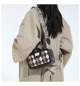 Detail of checkered crossbody bag with geometric wide strap and gold hardware