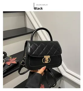 Close-up of black quilted PU leather handbag featuring elegant gold T-bar metal lock clasp