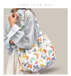 Floral butterfly print canvas tote bag shown on model for daily commuting style