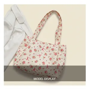 Detail of comfortable wide shoulder straps on a floral tote bag with rose patterns