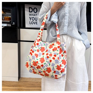 Floral canvas tote bag shown on shoulder in a bright lifestyle kitchen setting
