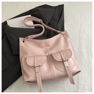 Detail of pink faux leather tote bag with functional double front flap pockets