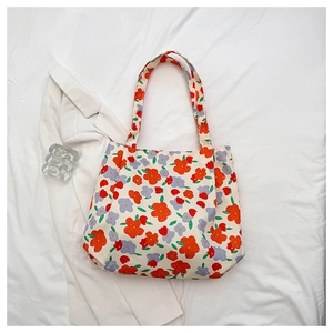 Detailed overhead view of floral tote bag with vibrant orange and purple flower patterns