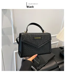 Close-up of black woven leather handbag with gold hardware and top handle detail