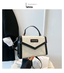 Detail of woven white leather texture and black trim with Fashion Bag label