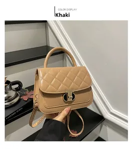 Detail of khaki quilted shoulder bag featuring gold twist lock and elegant top handle
