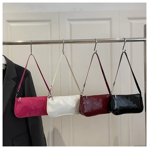 Row of minimalist glossy patent leather shoulder bags in pink, white, burgundy, and black