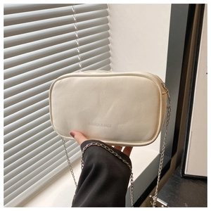 Detail of cream PU leather crossbody bag with metal chain strap and fashion letter print