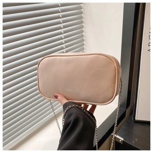 Detail of light pink PU leather mini makeup bag with chain strap and brand text
