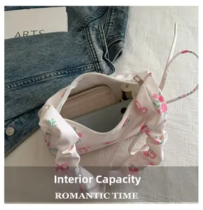 Detailed interior of floral canvas bag showing storage for phone, wallet and lipstick