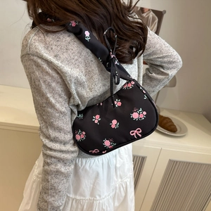 Floral canvas underarm bag with pink roses and bow prints on black fabric