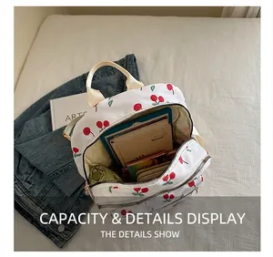 Interior capacity show of a white cherry print backpack with tablet and umbrella