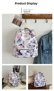 Detail of floral butterfly print backpack with gold zippers and adjustable white straps