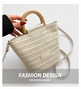 Detail of woven straw bucket bag showing round wooden handle and texture