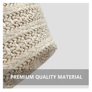 Macro detail of the natural handwoven texture and reinforced stitching on straw bucket bag