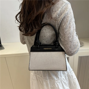 Large contrast color tote bag with black leather and beige canvas texture for summer