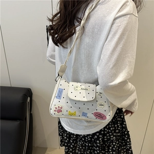 Chic white polka dot shoulder bag with colorful cartoon patches and elegant slim strap