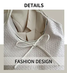 Detail of white woven leather tote bag with elegant bow tie decoration and checkerboard texture