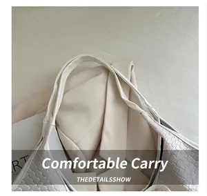 Detailed close-up of premium woven texture and smooth leather handle on a white tote bag