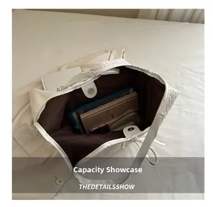 Interior view of white woven tote bag showing large capacity for tablet and notebook
