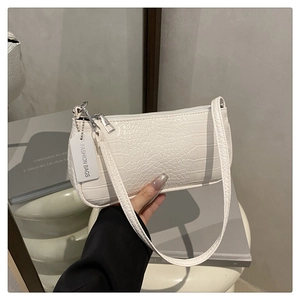 Detailed view of the white crocodile texture underarm bag with silver zipper and slim strap