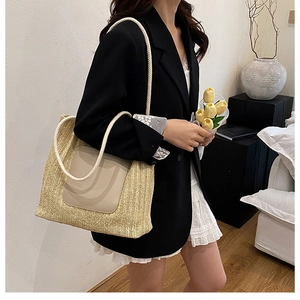 Détail d'un sac cabas en paille tissé main avec anses en corde crème et patch en cuir