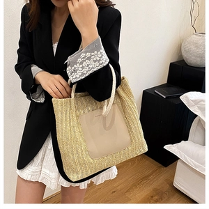 Close-up of woven straw tote bag featuring fashion leather patch and rope handles
