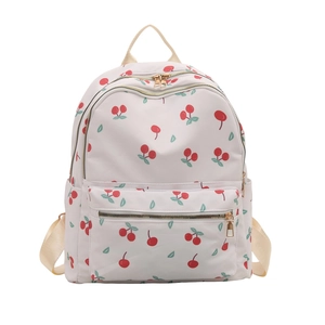 Student backpack with red cherry print and gold zippers on off-white durable fabric
