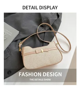 Detail shot of straw texture underarm bag with leather bow on a blazer backdrop