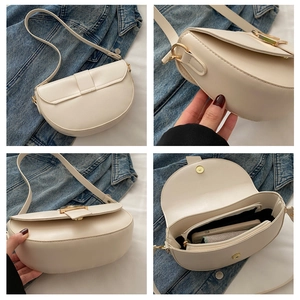 Detail view of cream saddle bag showing interior compartments for phone and wallet