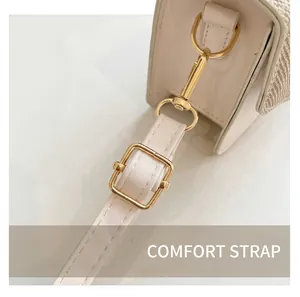 Detail of adjustable strap with gold-tone hardware on minimalist beige leather handbag
