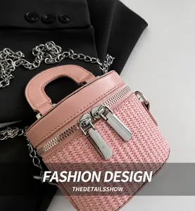 Detailed macro view of pink woven texture, silver dual zippers, and metal chain on handbag