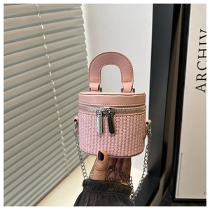 Detail of pink woven leather bucket bag featuring silver double zippers and metal chain