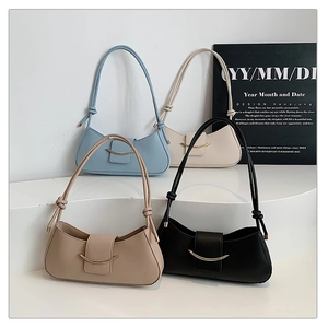 Minimalist underarm bags in blue, white, khaki, and black with metal crescent buckles