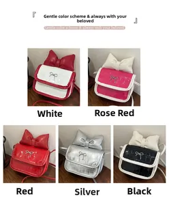 Detail of five mini crossbody bags with crocodile texture and large bow decoration