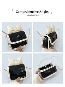 Detail view of mini crossbody bag featuring black croc-embossed texture and white bow