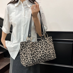 Fashionable leopard print canvas tote bag with black handles and gold metal rings