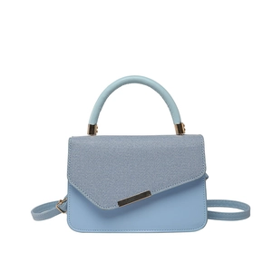 Light blue rectangular handbag with gold metal trim and detachable shoulder strap